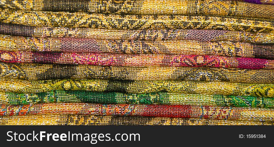 A collection of colorful fabric of different patterns and sizes