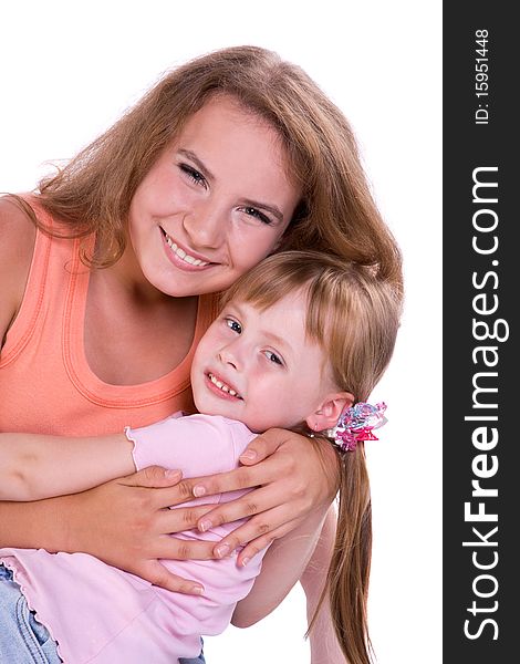 Two sisters. Two girls smiling is embracing.