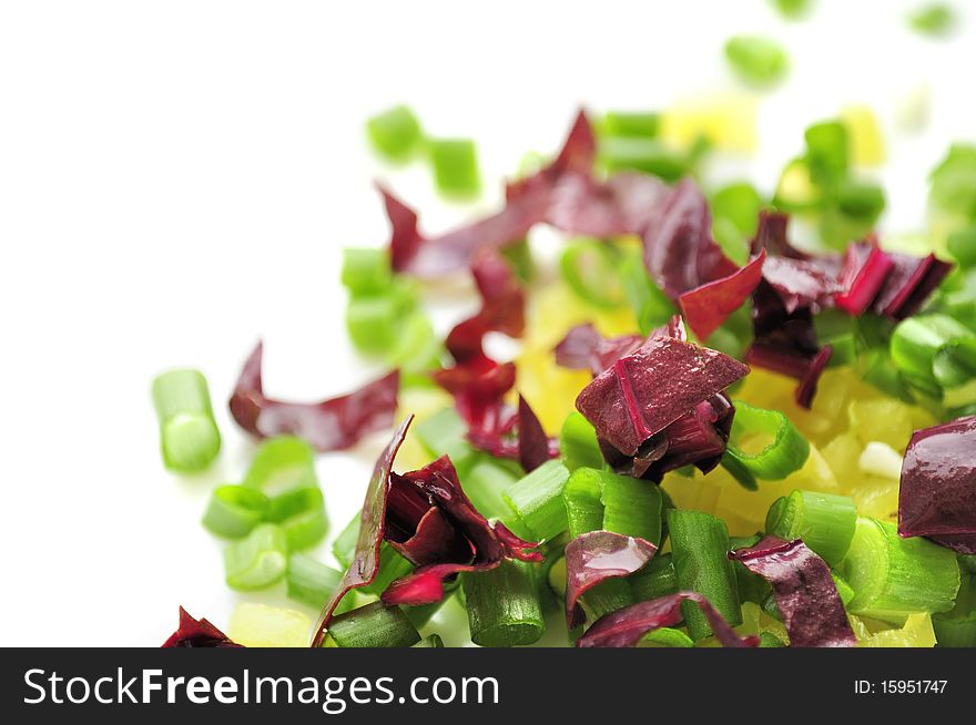 Chopped spring onion, red chard and sweet pepper on a white background