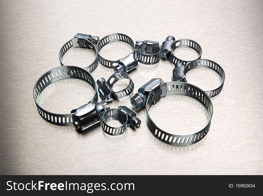 Hose clamp assortment on stainless background