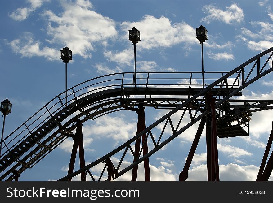 Fragment of the attraction roller coaster close against the sky