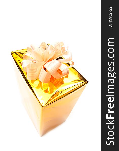 One golden gift box isolated on white. One golden gift box isolated on white