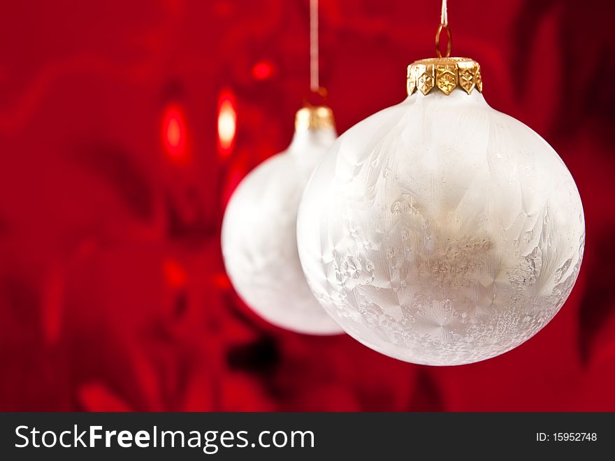 Christmas white baubles on red background.Studio shot. Christmas white baubles on red background.Studio shot