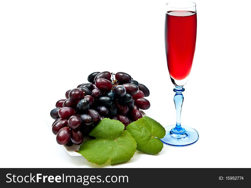 Red wine in glass with plump grapes. Isolated on white. Soft shadow. Red wine in glass with plump grapes. Isolated on white. Soft shadow