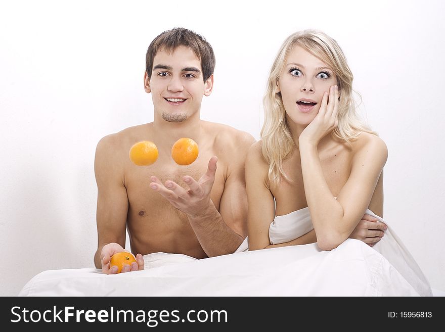 Young couple enjoying breakfast in bed