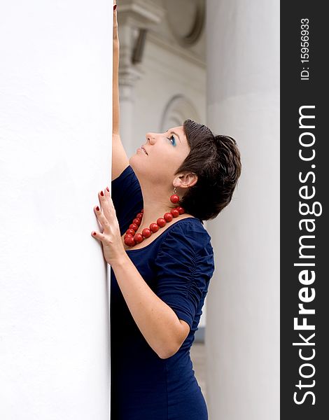 Sexy girl posing in front of columns outdoor