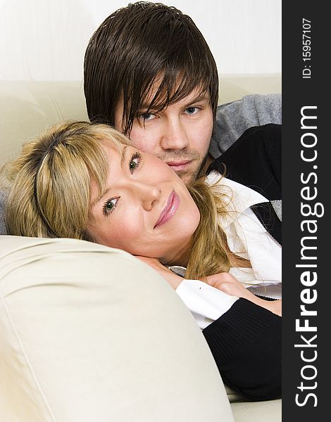 Couple relaxing at home on sofa