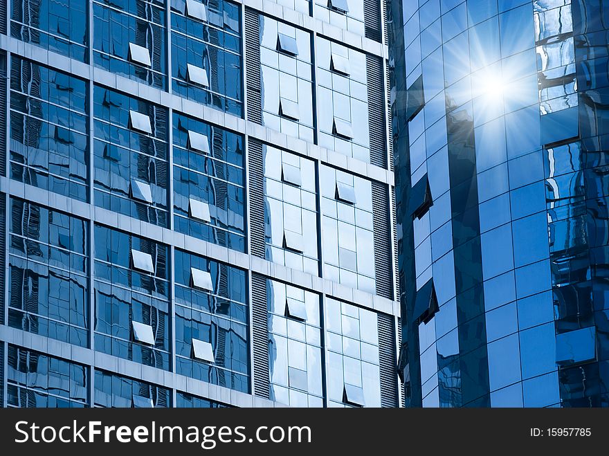 Ray on modern building glass wall