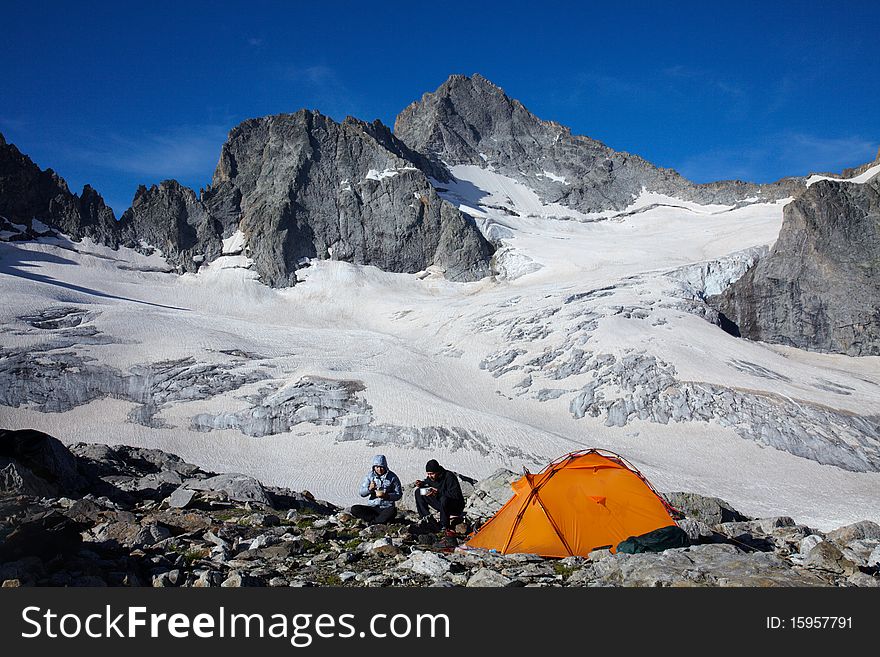 Couple of tourists having a breakfast in high mountains