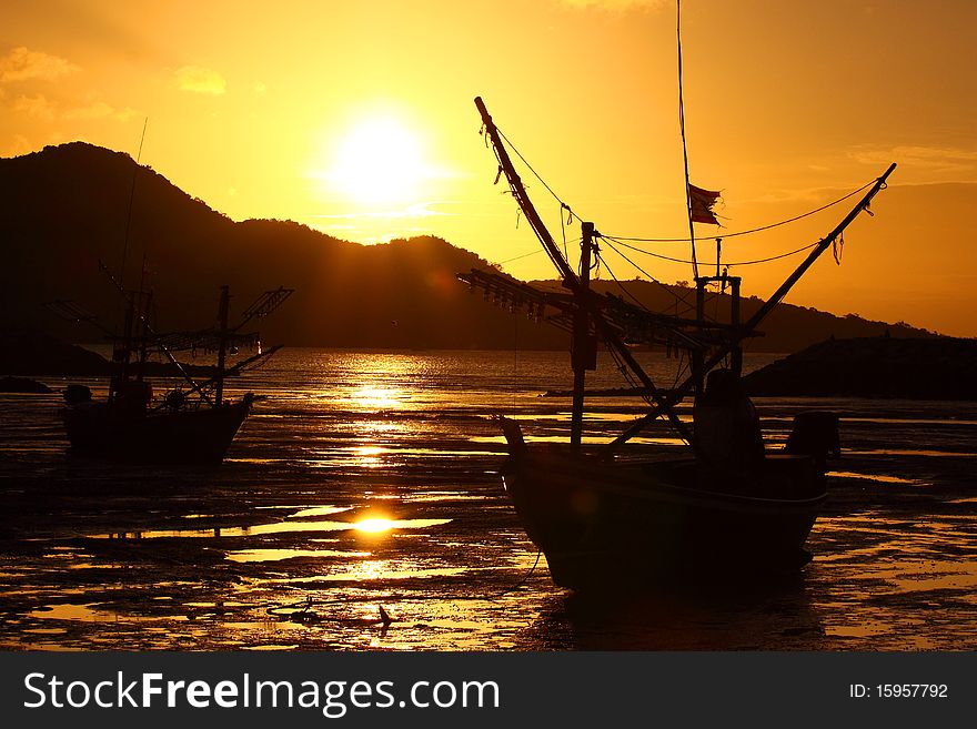 Sunshine and fishing boat on the betch