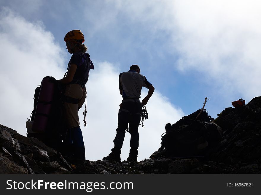 Couple of mountaneers on the top of mountain