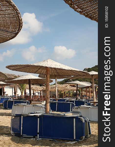 Low season beach with umbrellas and lounge. Low season beach with umbrellas and lounge