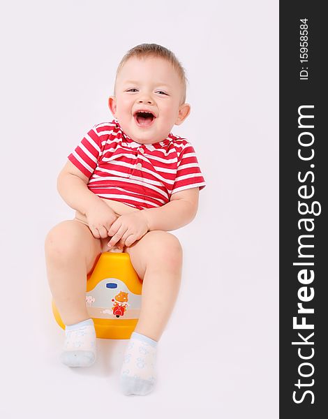 Child is sitting on the pot. Child is sitting on the pot