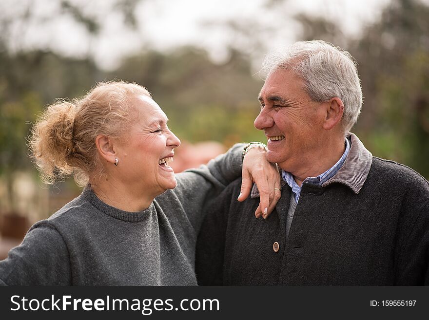 Beautiful and happy senior couple, smiling outdoors