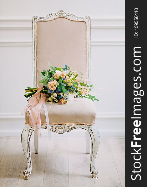 Stylish Wedding Bouquet On Vintage Wooden Chair With Drapery.