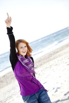 Red-haired Girl With Headphone On The Beach. Royalty Free Stock Photos Red-haired Girl With Headphone On The Beach. Royalty Free Stock Photos
