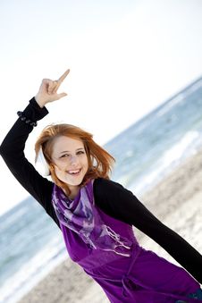 Red-haired Girl With Headphone On The Beach. Stock Images Red-haired Girl With Headphone On The Beach. Stock Images