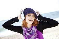 Red-haired Girl With Headphone On The Beach. Royalty Free Stock Photo Red-haired Girl With Headphone On The Beach. Royalty Free Stock Photo