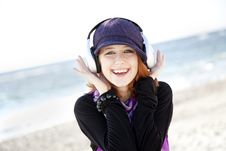 Red-haired Girl With Headphone On The Beach. Royalty Free Stock Photography Red-haired Girl With Headphone On The Beach. Royalty Free Stock Photography