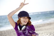 Red-haired Girl With Headphone On The Beach. Stock Photography Red-haired Girl With Headphone On The Beach. Stock Photography