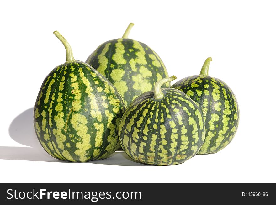 Four green small watermelons on white