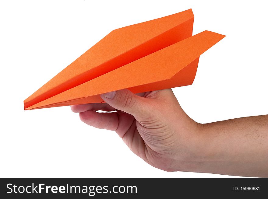 Orange color paper airplane in the hand isolated over white background. Orange color paper airplane in the hand isolated over white background