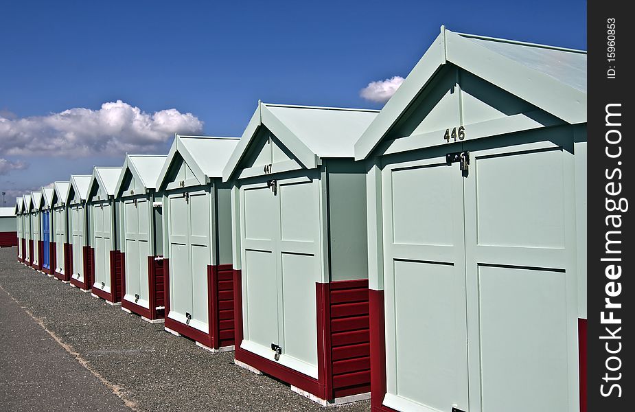 A row of blue beach huts on a sea-front