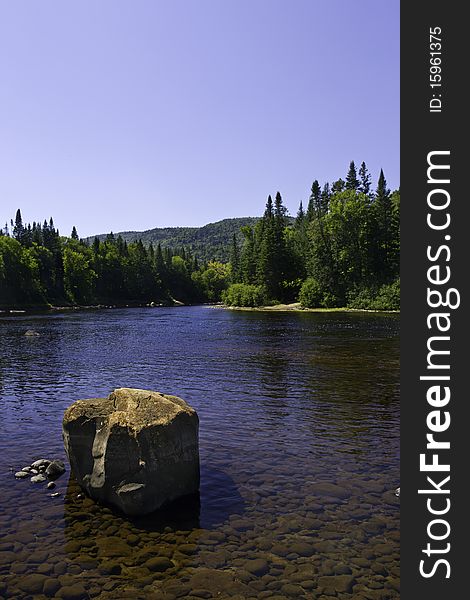 Beautiful view from quebec canada. Landscape with river tree mountain and a big stone. Beautiful view from quebec canada. Landscape with river tree mountain and a big stone.