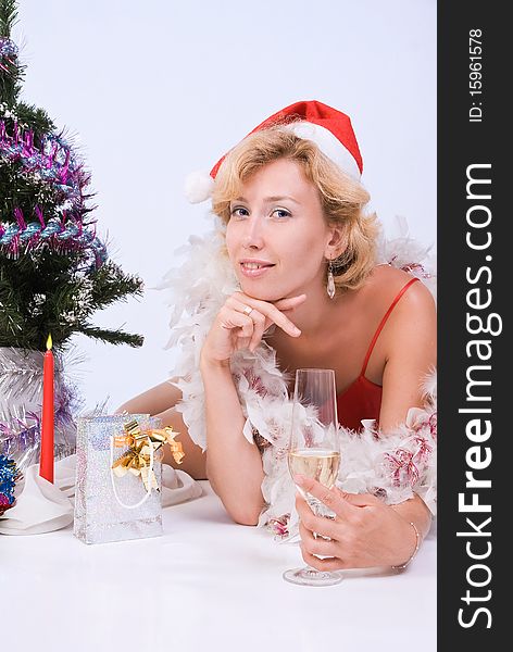 Beautiful woman wearing santa claus clothes with wine glass. Beautiful woman wearing santa claus clothes with wine glass