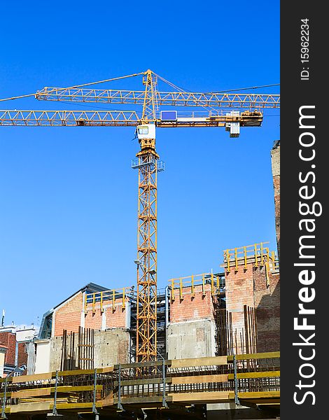 Building crane and building under construction on blue sky, Vienna, Austria