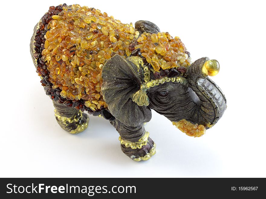 Amber toy elephant on a white background