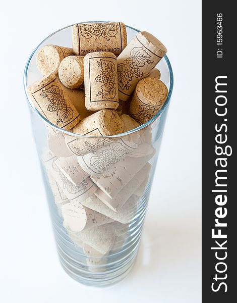 Wine cork in a glass on white background