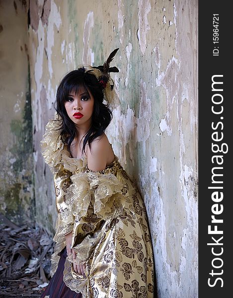 Chinese woman wearing victorian costume shoot at grunge building. Chinese woman wearing victorian costume shoot at grunge building