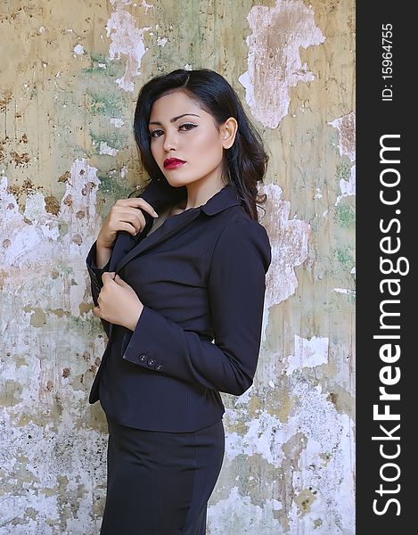 Pretty business woman wearing black suit, posing at outdoor. Pretty business woman wearing black suit, posing at outdoor