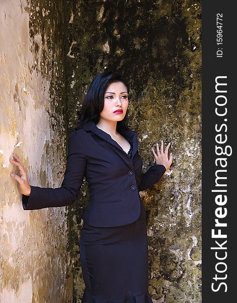 Pretty business woman wearing black suit, posing at outdoor. Pretty business woman wearing black suit, posing at outdoor