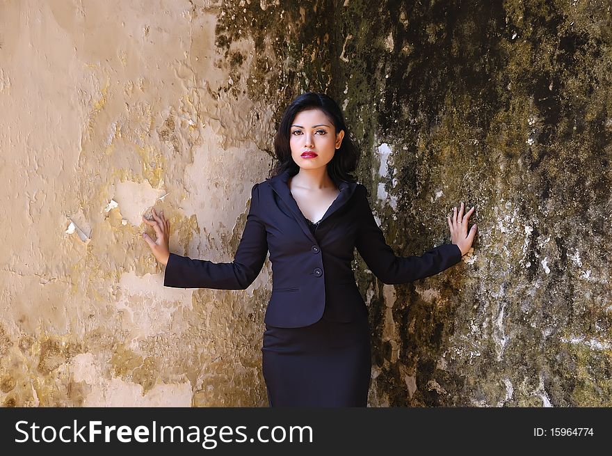 Pretty business woman wearing black suit, posing at outdoor. Pretty business woman wearing black suit, posing at outdoor