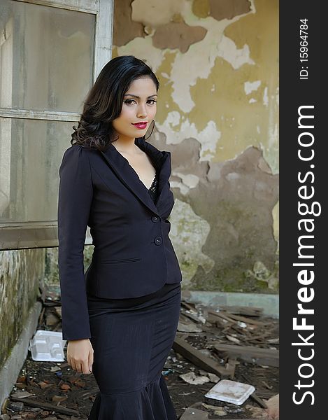 Pretty business woman wearing black suit, posing at outdoor. Pretty business woman wearing black suit, posing at outdoor