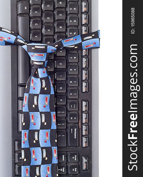 Neck Tie Around Computer Keyboard for business fashion/professional attire concepts. Neck Tie Around Computer Keyboard for business fashion/professional attire concepts