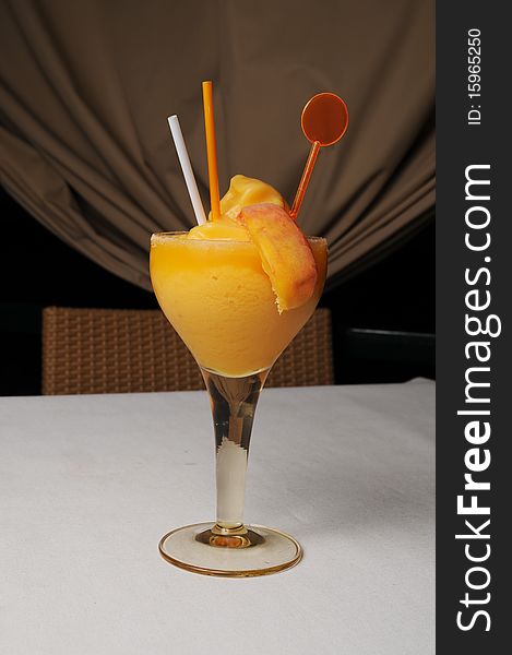 Fruit cocktail with icecream in glass with straw