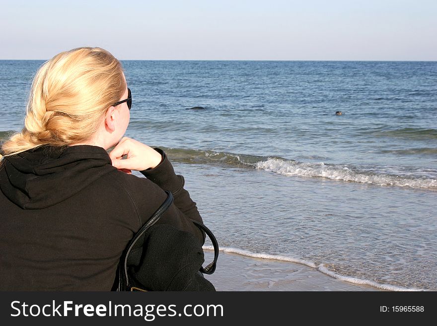 Girl Watching Seals At The Coast Of Helgoland