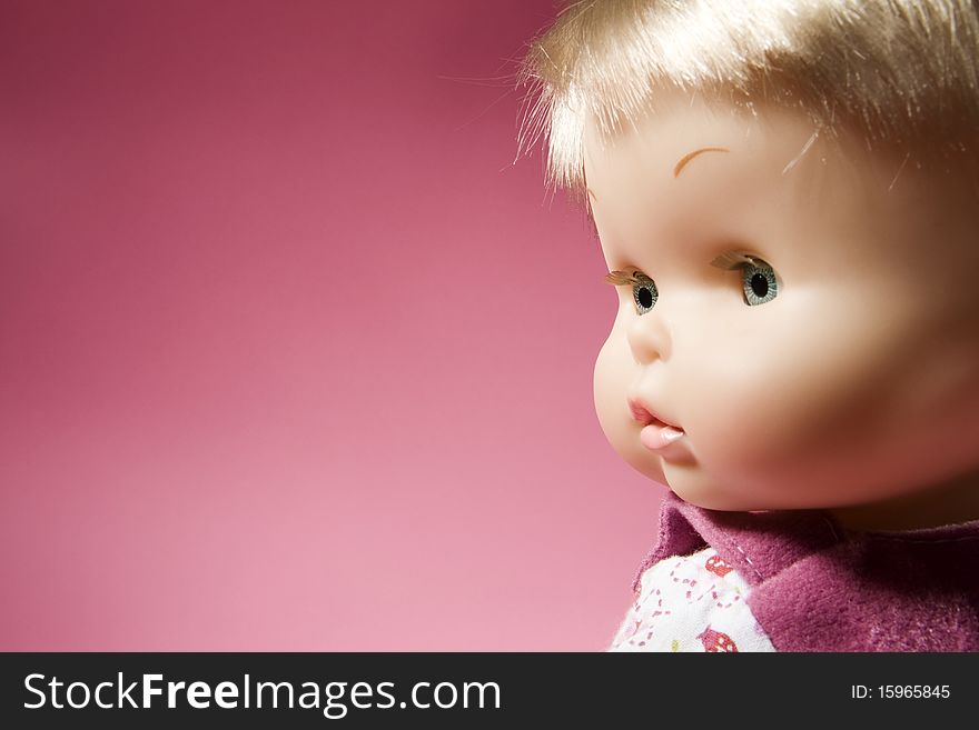 Doll Face on Pink Background Looking Lfet. Doll Face on Pink Background Looking Lfet