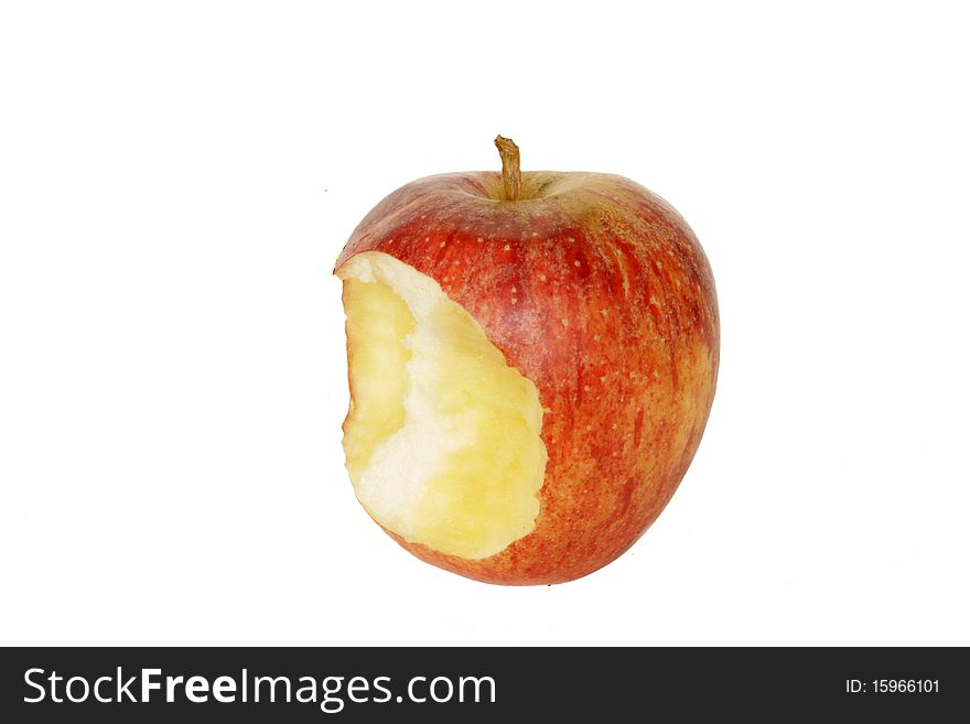 Nibbled ripe red apple in isolated over white background