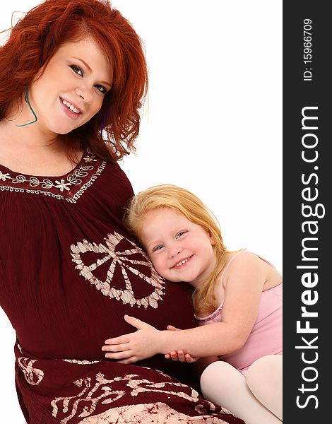 Beautiful pregnant 23 year old american woman with three year old daughter over white background. Beautiful pregnant 23 year old american woman with three year old daughter over white background.
