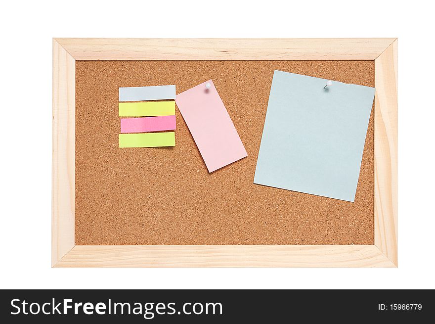 Corkboard with empty blue pink and yellow notes