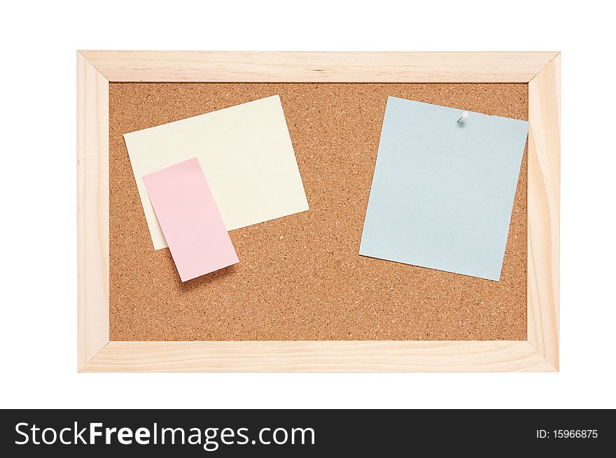 Corkboard with empty blue pink and yellow notes