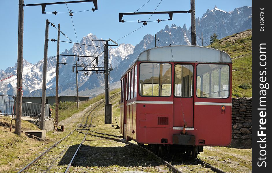 View of rail and coach with mountains in background. View of rail and coach with mountains in background.