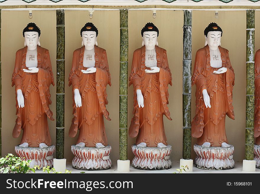 A row of Buddhas at the Kek Lok Si temple, in Penang, Malaysia. A row of Buddhas at the Kek Lok Si temple, in Penang, Malaysia