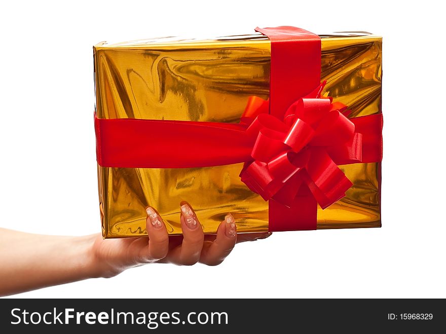 Female hand holding a yellow christmas gift. Isolated on white background. Female hand holding a yellow christmas gift. Isolated on white background