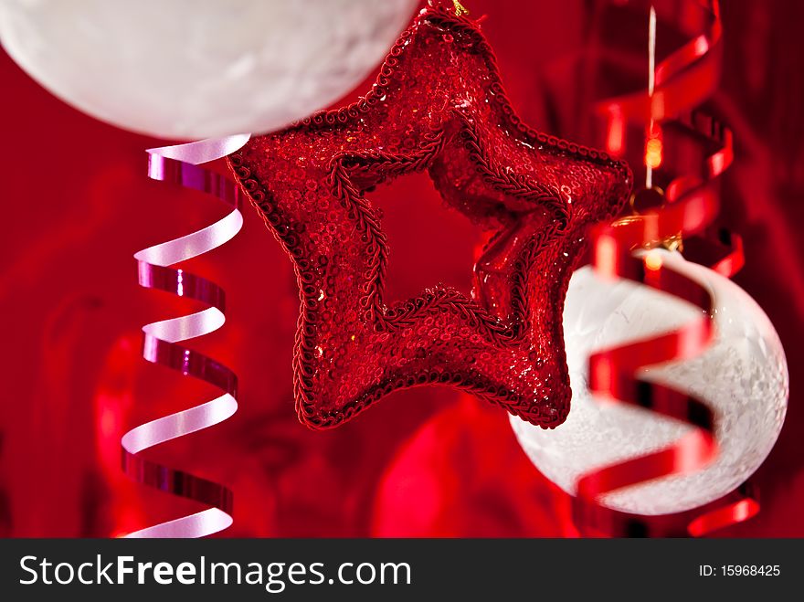 Beautiful christmas star and white baubles on red background