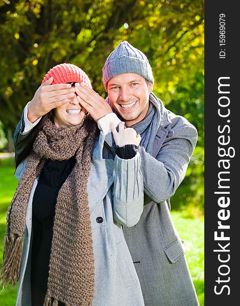 Embracing laughing love couple in autumn season